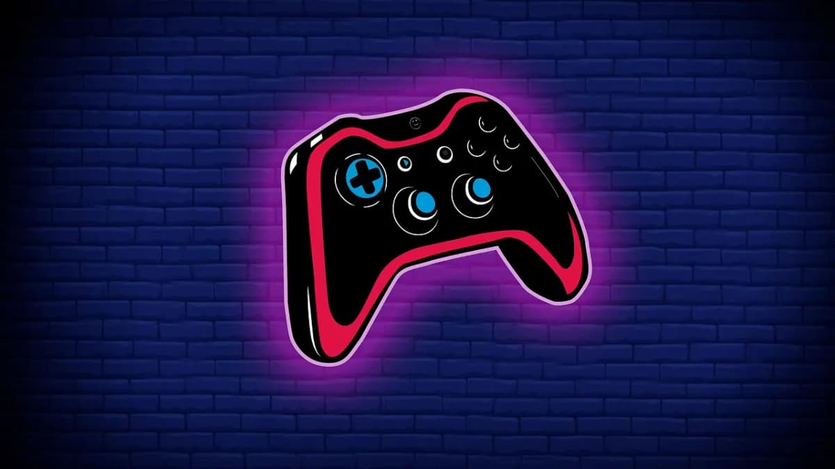 Neon game controller sign glowing on a dark blue brick wall