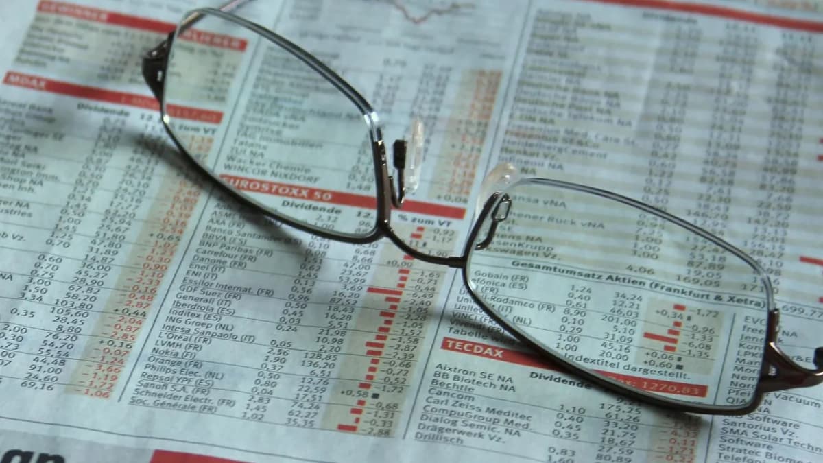 Reading glasses resting on the stock market pages of a newspaper