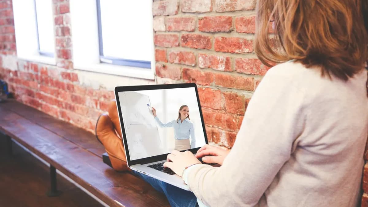 Woman at a laptop watching an online video lesson