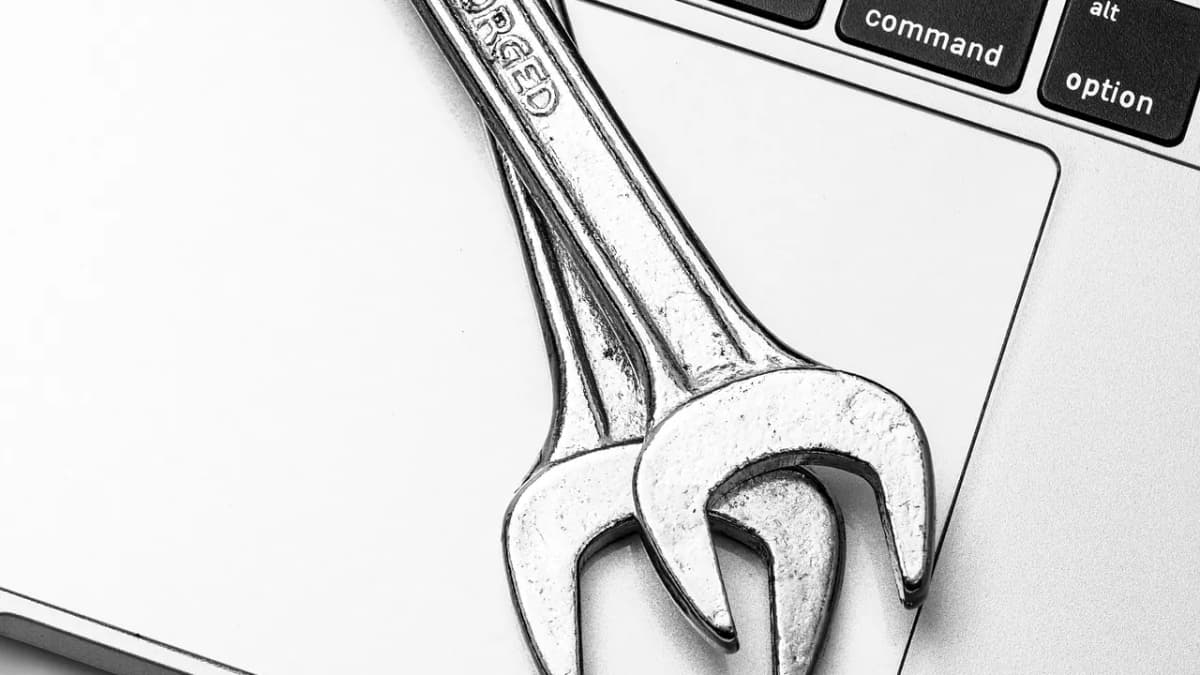 Two wrenches resting on a laptop keyboard